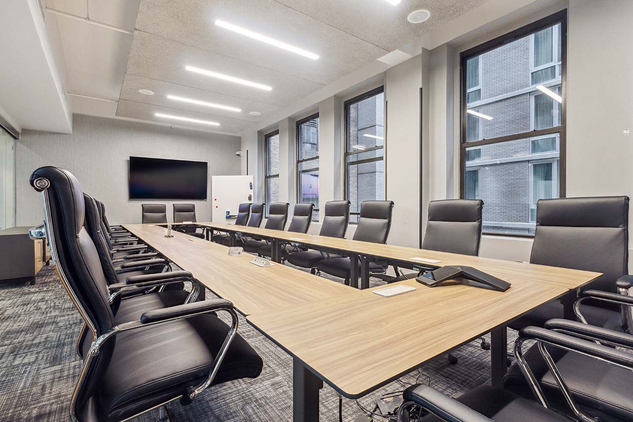 A meeting room with large black office chairs.